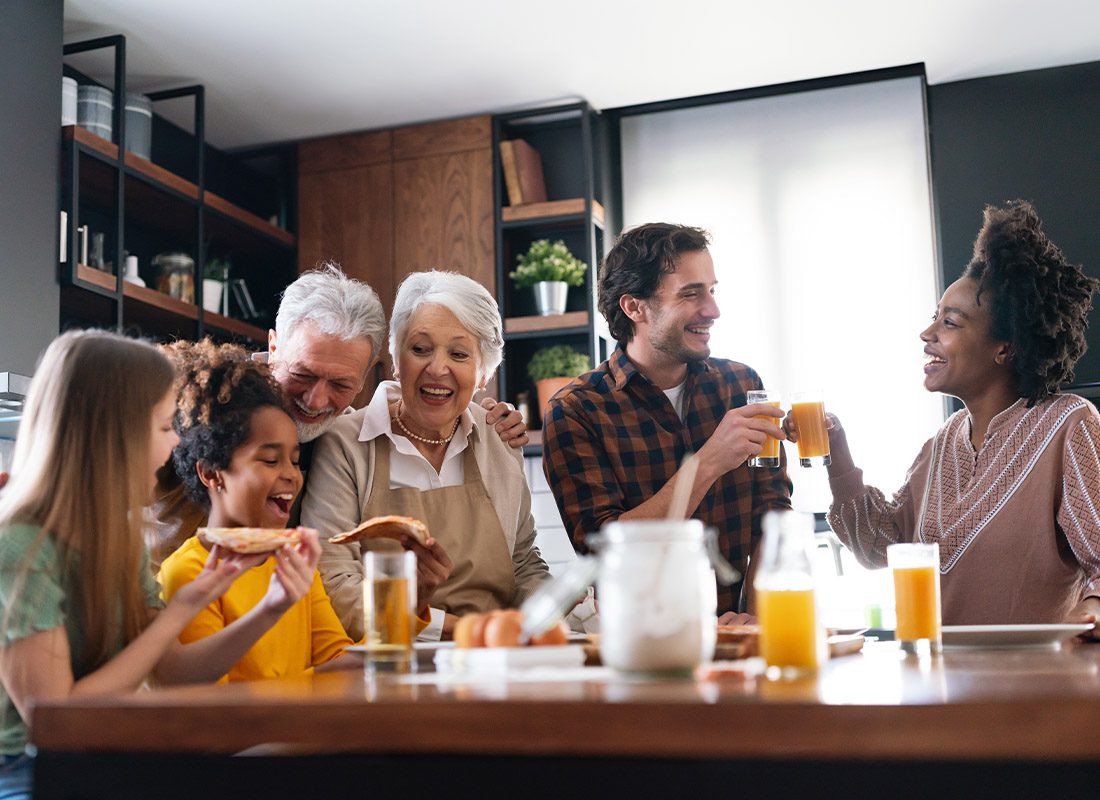 About Our Agency - Happy Multigenerational Family at the Kitchen Table