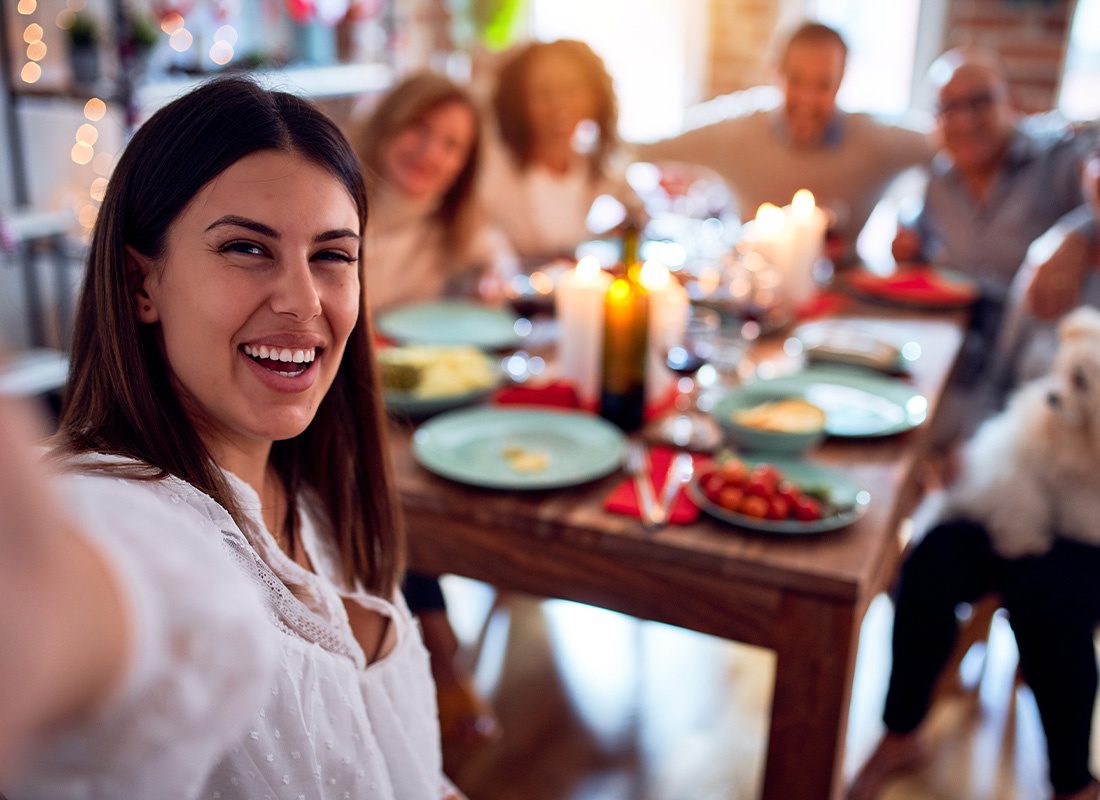 Read Our Reviews - Family and Friends Dining at Home Celebrating a Holiday With Traditional Food and Decorations and Taking a Selfie Picture Together